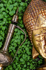 golden buddha head and a magic lamp
