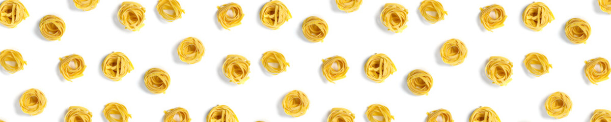 background from Italian tagliatelle pasta. raw pasta fettuccine, pop art background, flat lay. Italian raw nest pasta isolated on white. not seamless pattern