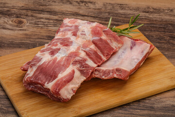Raw pork ribs served rosemary