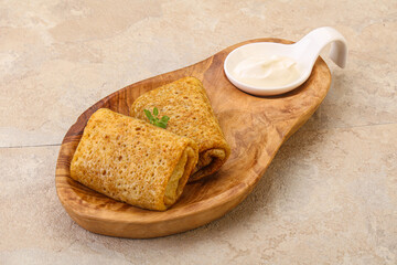 Staffed pancakes served sour cream