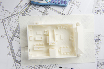 Top view of 3D model of the house printed on a 3D printer with white filament by FDM technology and...