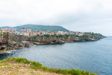 Fototapeta na wymiar Coast full of houses of the Lekeitio municipality, Bay of Biscay in the Cantabrian Sea. Basque Country