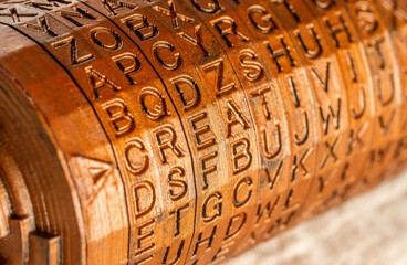 Close-up of brass cryptex invented by Leonardo da Vinci from the book da vinci code. Word creativity as password set by letters rings. Cryptographic equipment printed on a 3D printer.