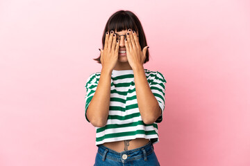 Young mixed race woman isolated on pink background covering eyes by hands