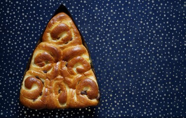 Delicious New Year's pie with raisins on a blue background. Close-up 