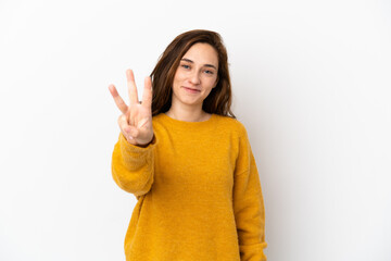 Young caucasian woman isolated on white background happy and counting three with fingers