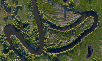Aerial view of winding river bed with ducts.