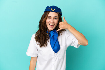 Airplane stewardess woman isolated on blue background making phone gesture. Call me back sign