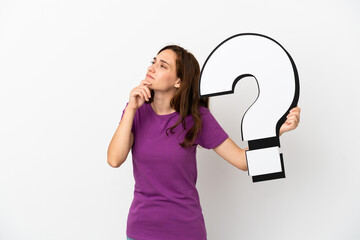 Young caucasian woman isolated on white background holding a question mark icon and having doubts