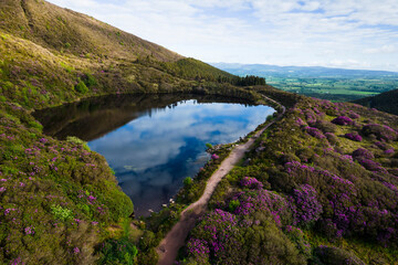 Bay Lough lake in Clogheen, county Tipperary in Ireland. The lake sits on a slope in the midst of the Knockmealdown mountains, looks like a mirror due to its black water and is surrounded by green for