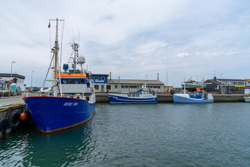 Naklejka na ściany i meble colorful fishing boats in the industrial port and harbor of Hirtshals
