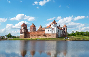 Ancient castle in the city of Mir in western Belarus with reflection in the lake.