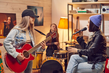 Girl with microphone singing among her friends with musical instruments