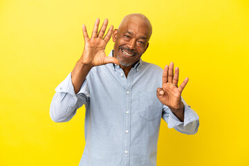 Cuban Senior isolated on yellow background counting nine with fingers