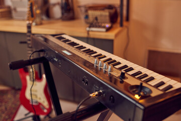 Synthesizer and electric guitar in contemporary studio of sound recording