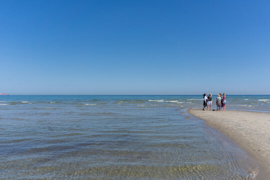 five women standing at the northern tip of Denmark where the Baltic Sea and North Sea meet at Skagen Reef