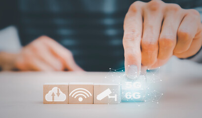 Start success business 5g to 6g  beginning business successful, Hand holding wood cubes with icon and goal or target icon, concept future technology 5g- 6G network wireless systems