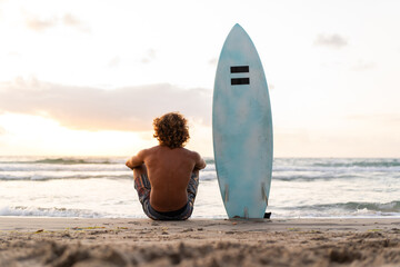 Young caucasian man get up early to  doing surf at sunrise - Powered by Adobe