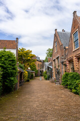 Fototapeta na wymiar picturesque neighborhood street with red brick buildings in the historic city center of Haarlem