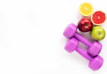 Fresh fruits for healthy eating and sports equipment (purple female kettlebells) Healthy food and sports concept