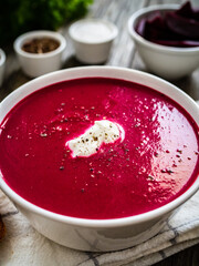 Beetroots cream soup on wooden table

