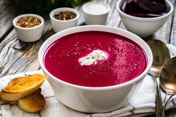 Beetroots cream soup on wooden table
