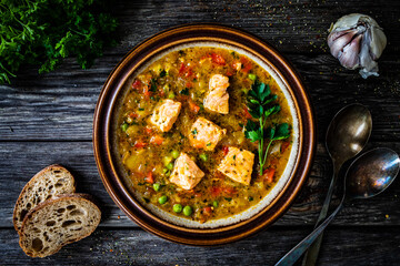 Fish soup on wooden table
