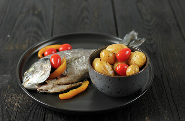 Fresh dorada on a black wooden board, freshly caught,  catch the fish