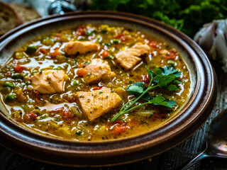 Fish soup on wooden table
