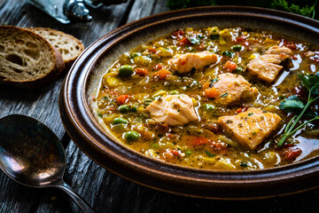 Fish soup on wooden table
