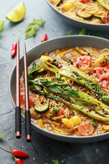 Asian style Pak choi, lemongrass, and ginger curried noodles served with lime wedges