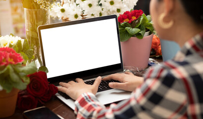 Online home flower arrangement concept, asian woman Smiling florist record video broadcast or course on smartphone or computer, compose arrange floral decorations,online flower shop