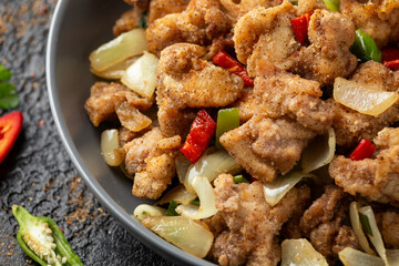 Stir fry chinese salt and pepper chicken with rice in grey bowl