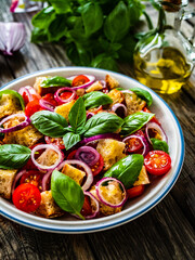 Classic panzanella salad on wooden board

