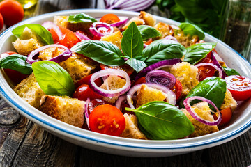 Classic panzanella salad on wooden board

