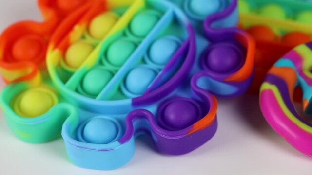 Anti-stress toys pop it, simble dimble, snapperz spinning on white background. Concept trendy entertainment for fidget children, sensory toys for development of fine motor skills, stress relieving