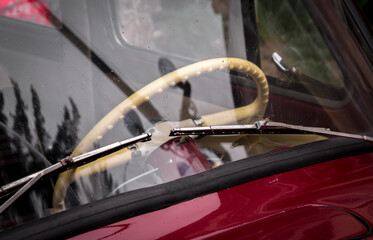 Retro car festival. View of the windshield and steering wheel on an old retro car. Fragment of the front of a retro car.