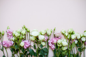 Delicate touching bouquet of white and pink flowers on a light pink background. Layout. Flat lay