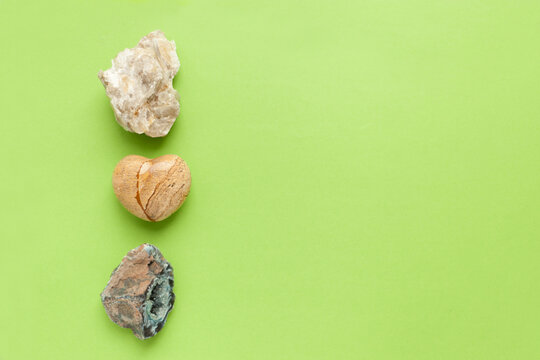 Backgrounds and textures, nature concept - rocks and minerals. Different minerals and heart stone on green background.