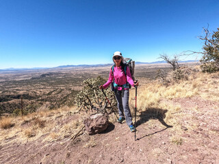 Trekking next to cholla cactus, Arizona Trail, Arizona, U. S. A