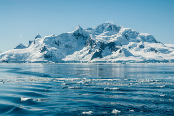 Snowy mountains in Paraiso Bay, Antartica.