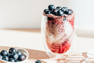 Healthy chia pudding in a glass with fresh blueberries