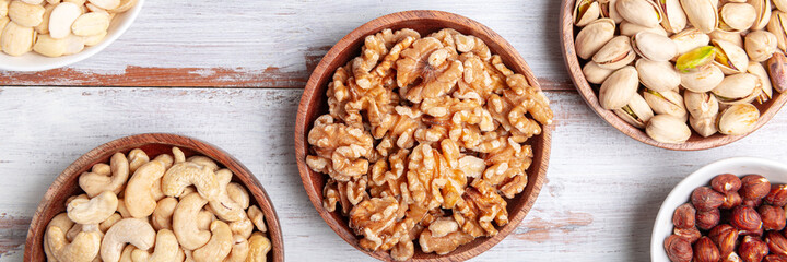 Different kind of nuts in wooden bowls