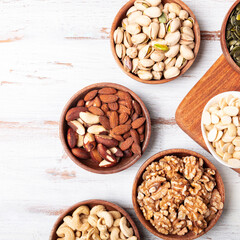 Different kind of nuts in wooden bowls