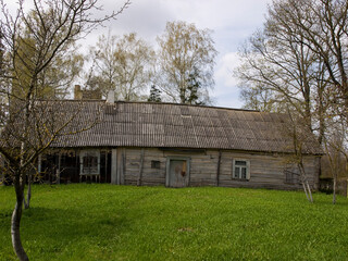 Fototapeta na wymiar Old village house with outbuildings.
