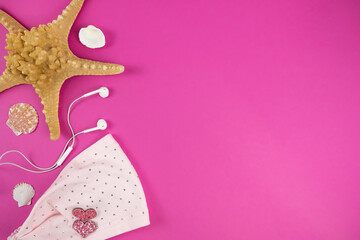 Dressing, headsets and seashells on color background. Summer background