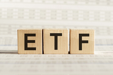 ETF abbreviation - Exchange Traded Fund, on wooden cubes on a light background.