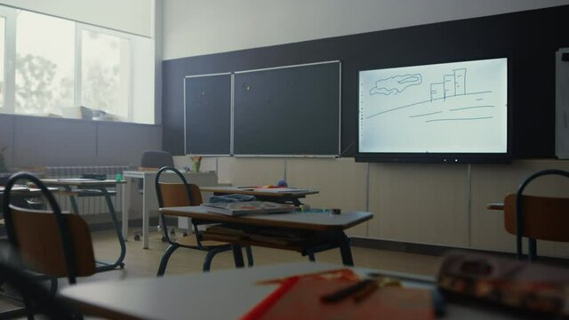Empty classroom interior. School room with modern projector screen on wall