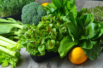 Broccoli, Cos Lettuce and Baby Spinach Leaves in arrangement. - obrazy, fototapety, plakaty
