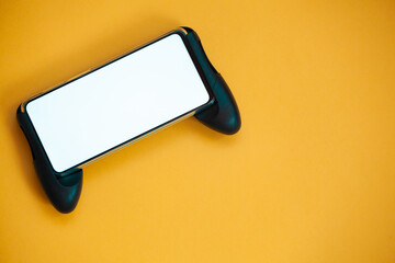 Joystick mobile phone, screen mockup Isolated on yellow background top view © perfectlab